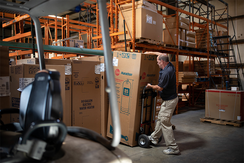 Employee loading stock in our backroom for our Chattanooga water heaters